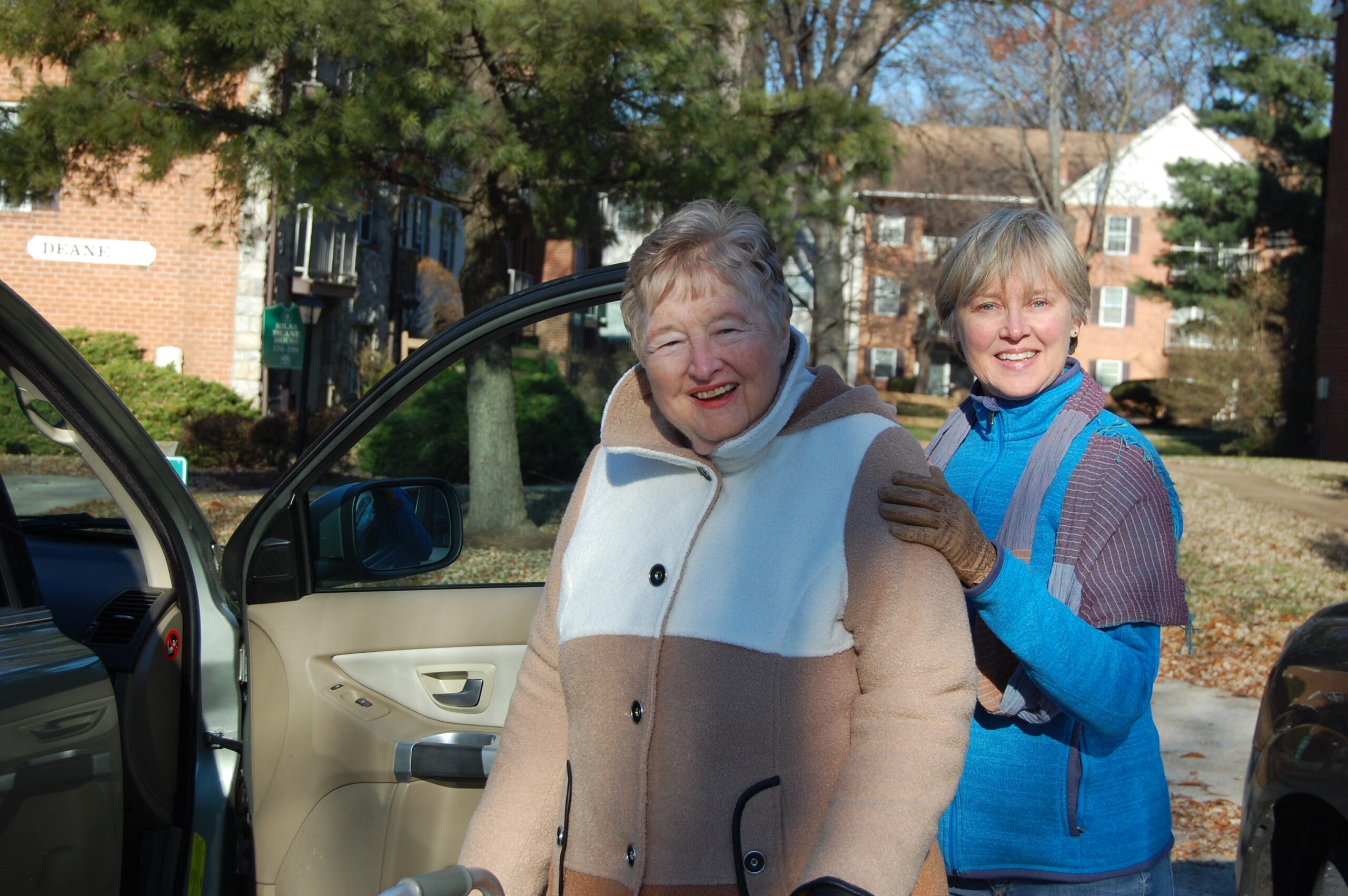 woman holding car door open