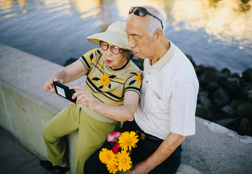 man standing talking and people sitting